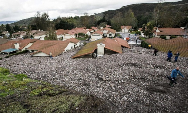 In southern California, houses once spared by wildfires were pummelled by rockslides after the rains. Photograph: Ringo H.W. Chiu/AP